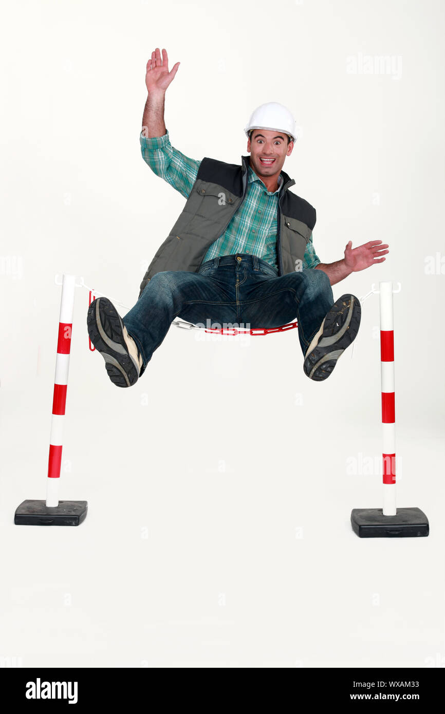Man jumping over safety barrier Stock Photo Alamy