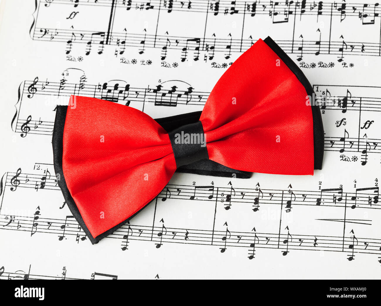 Red bow tie on music sheet Stock Photo