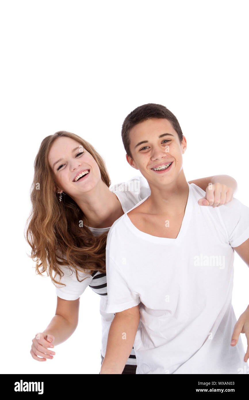 Laughing young teenagers having fun together with the girl draping her ...