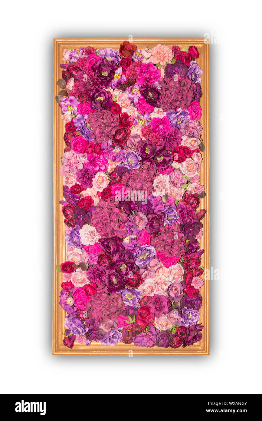 Beautiful purple artificial flowers in wooden frame isolated on white