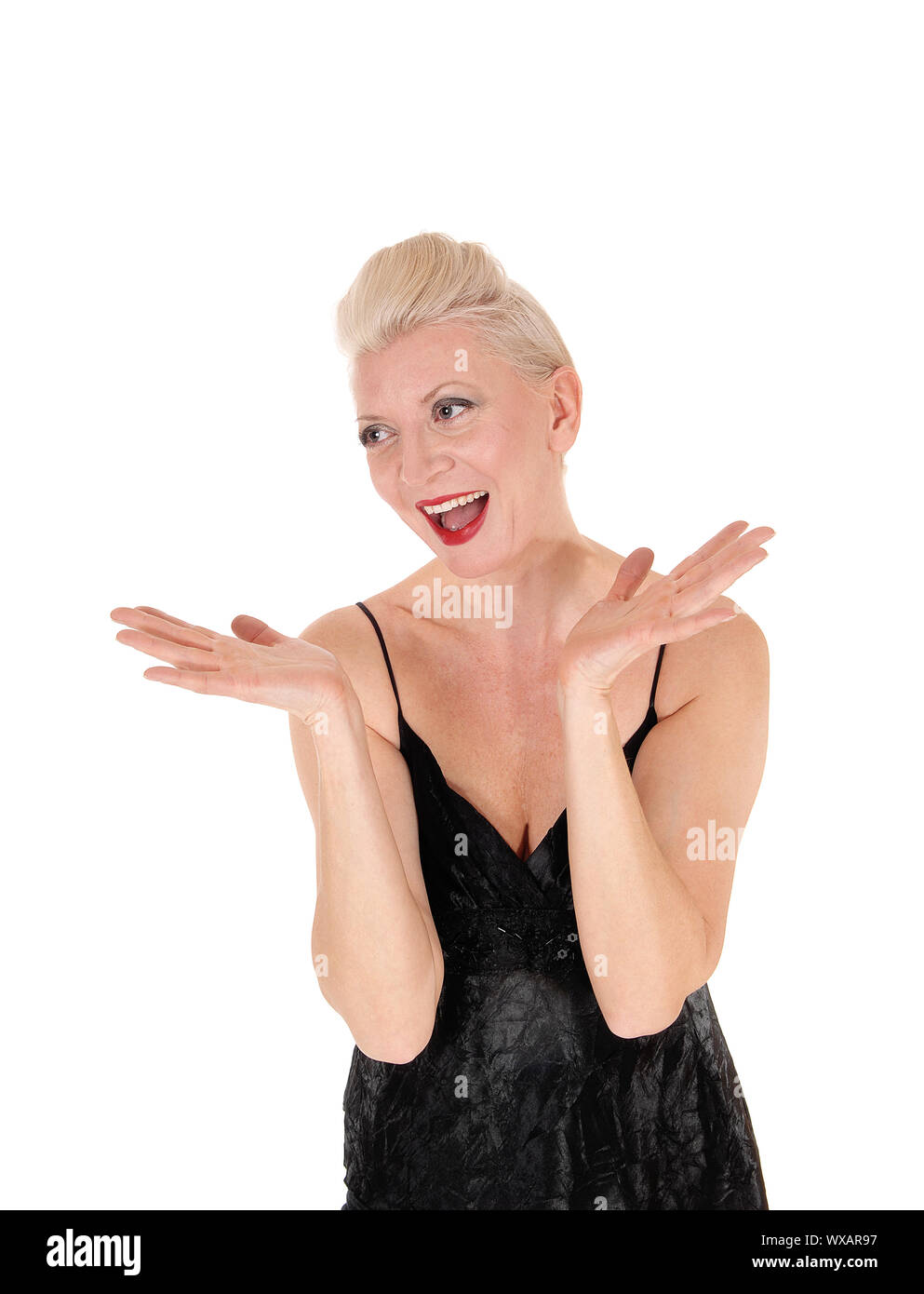 A happy laughing blond woman with her hands up Stock Photo