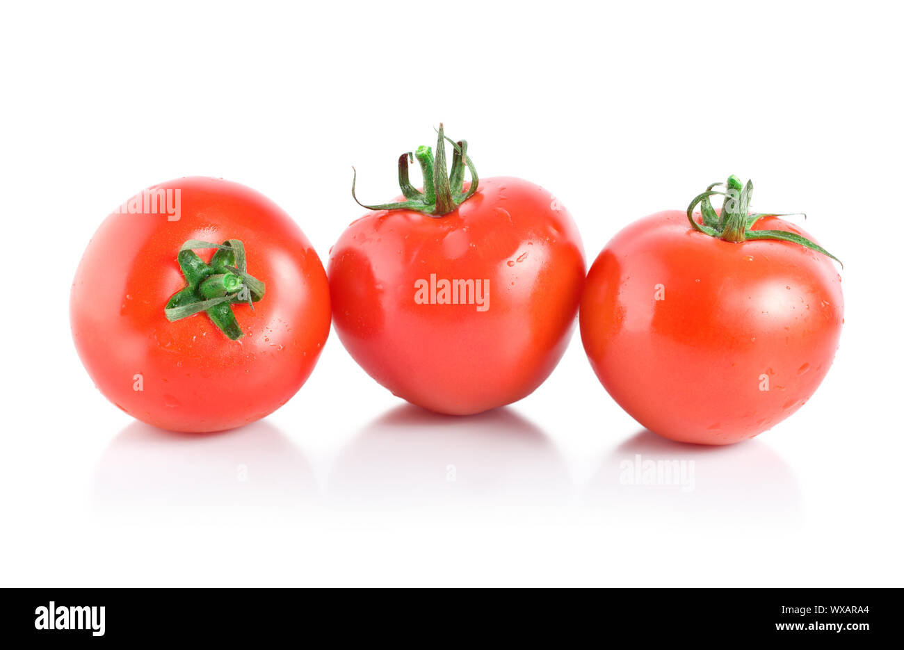 Three red tomatoes isolated on white background Stock Photo - Alamy
