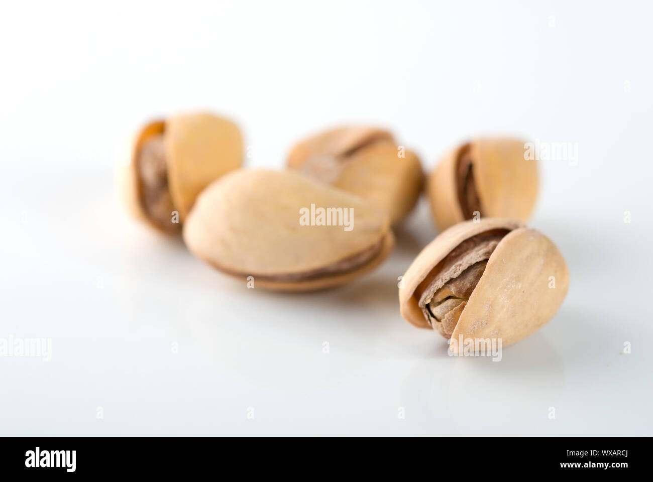 Handful of ripe pistachios on a white background Stock Photo Alamy