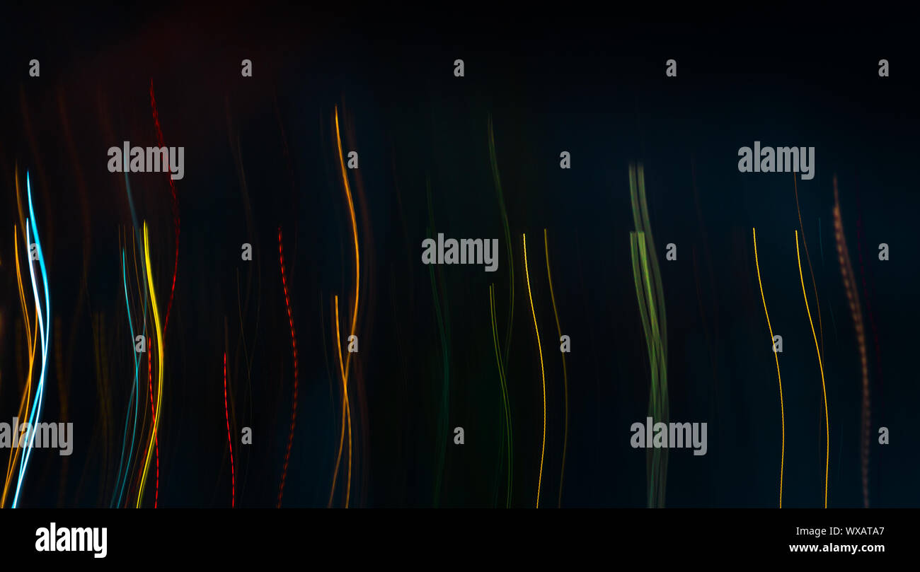 streaks of colorful lights on a black background Stock Photo - Alamy