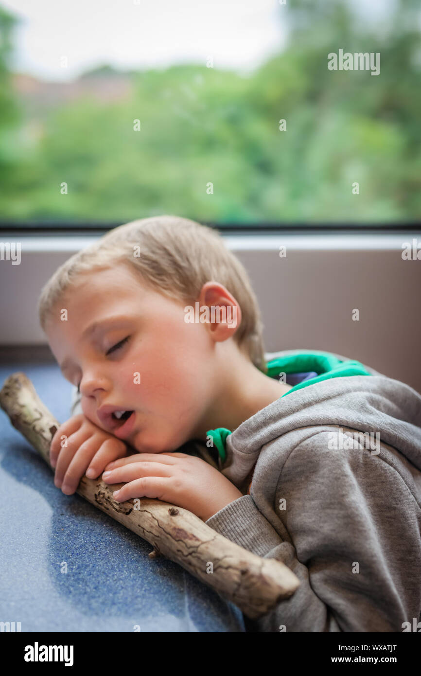 Little boy sleeping on a train Stock Photo