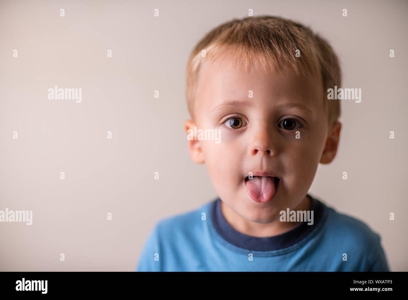 Cute boy sticking his tongue out Stock Photo Alamy