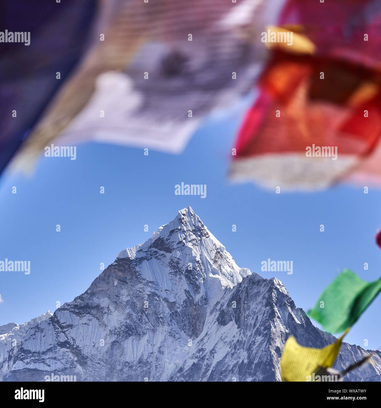 Peak of Ama Dablam with prayer flags in Nepal Stock Photo