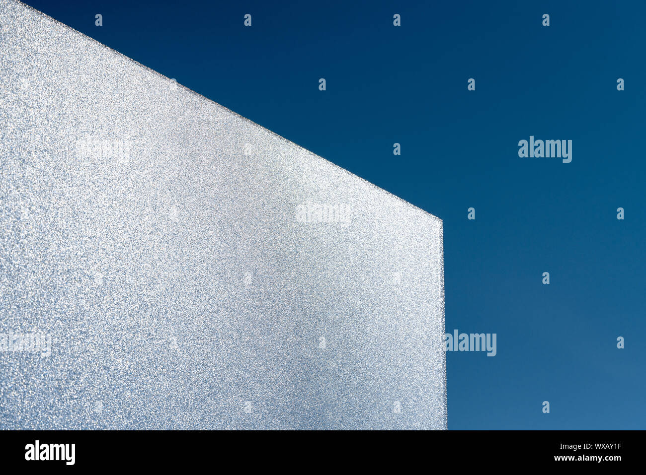 bright light intransparent glass pane reflects shimmering sunlight with  clear blue sky behind Stock Photo - Alamy