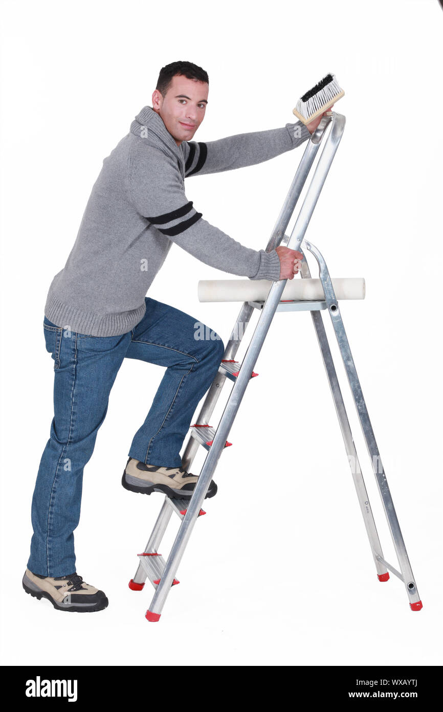 Man putting up wallpaper Stock Photo Alamy