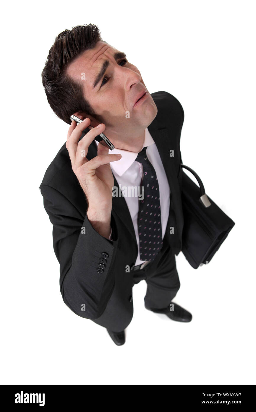 Businessman being nagged by his wife Stock Photo