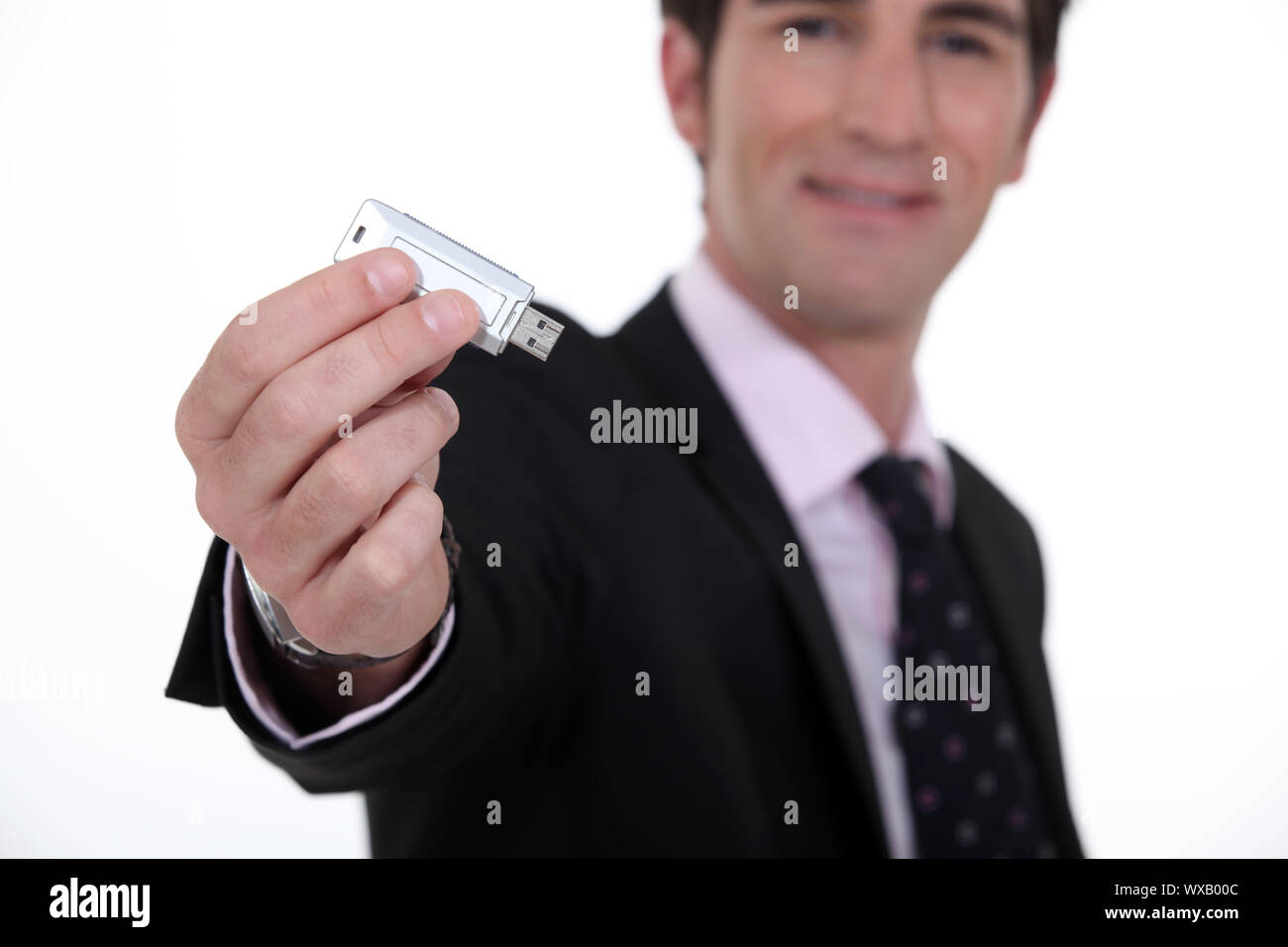 businessman holding a flash drive Stock Photo