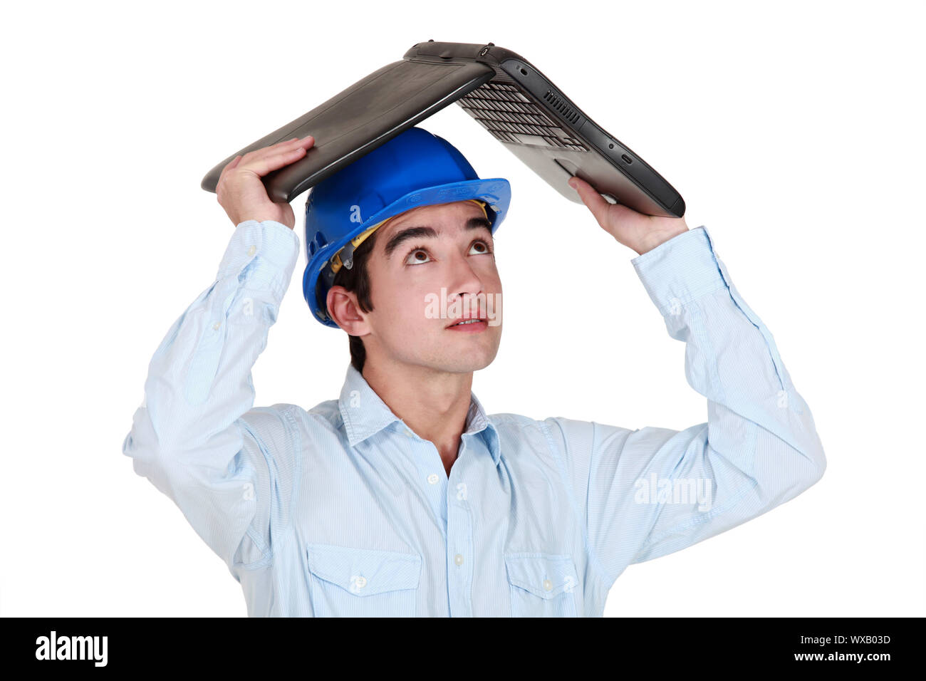 Man sheltering under his laptop Stock Photo - Alamy