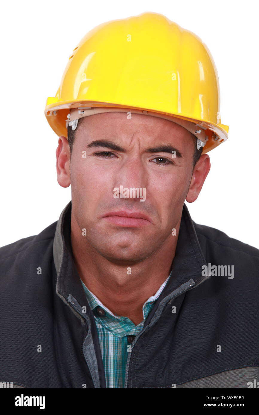 Sad man in a hard hat Stock Photo Alamy