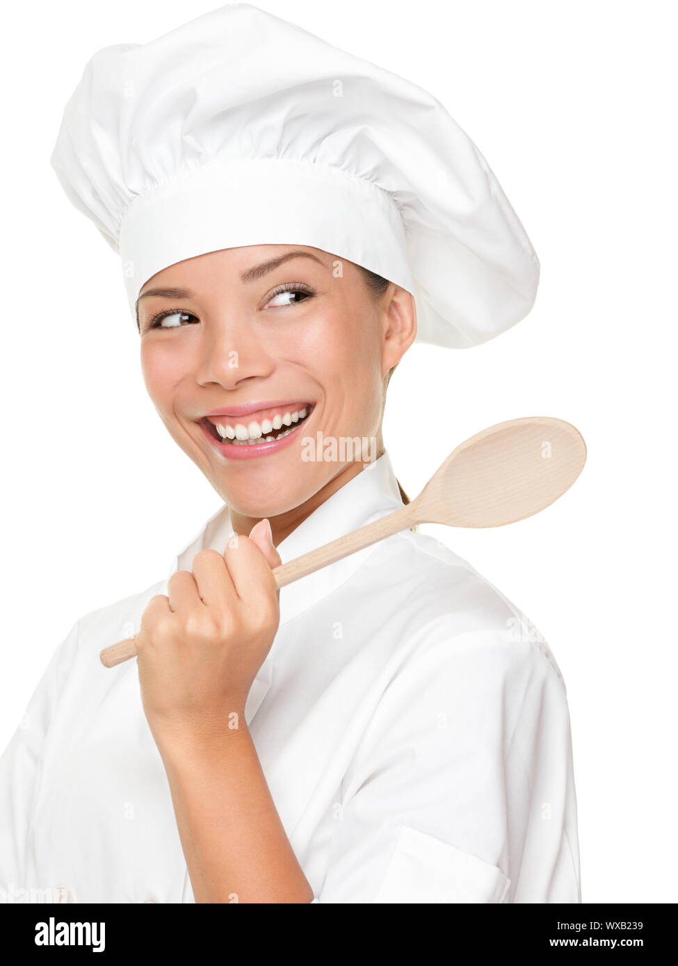Chef woman smiling happy. Cook, chef or baker looking over should at copy space holding wooden
