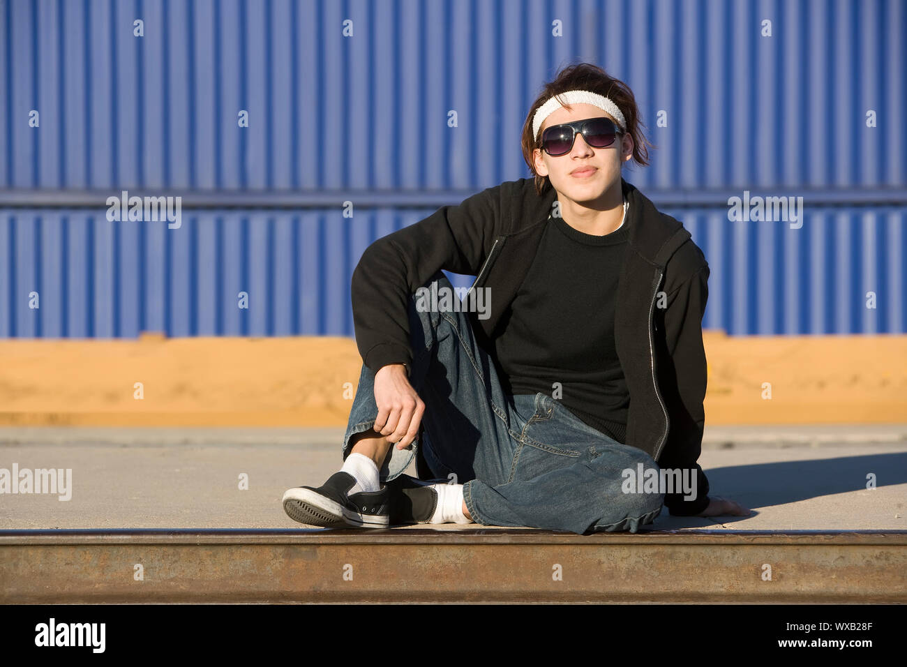 Teenage boy wearing glasses in front of train Stock Photo Alamy