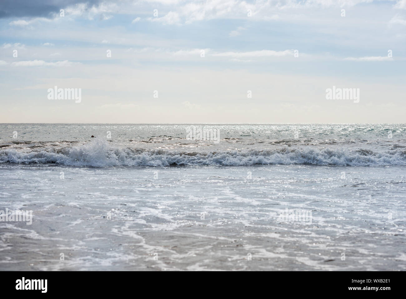 Seascape with sunlight reflection and calm waves Stock Photo - Alamy