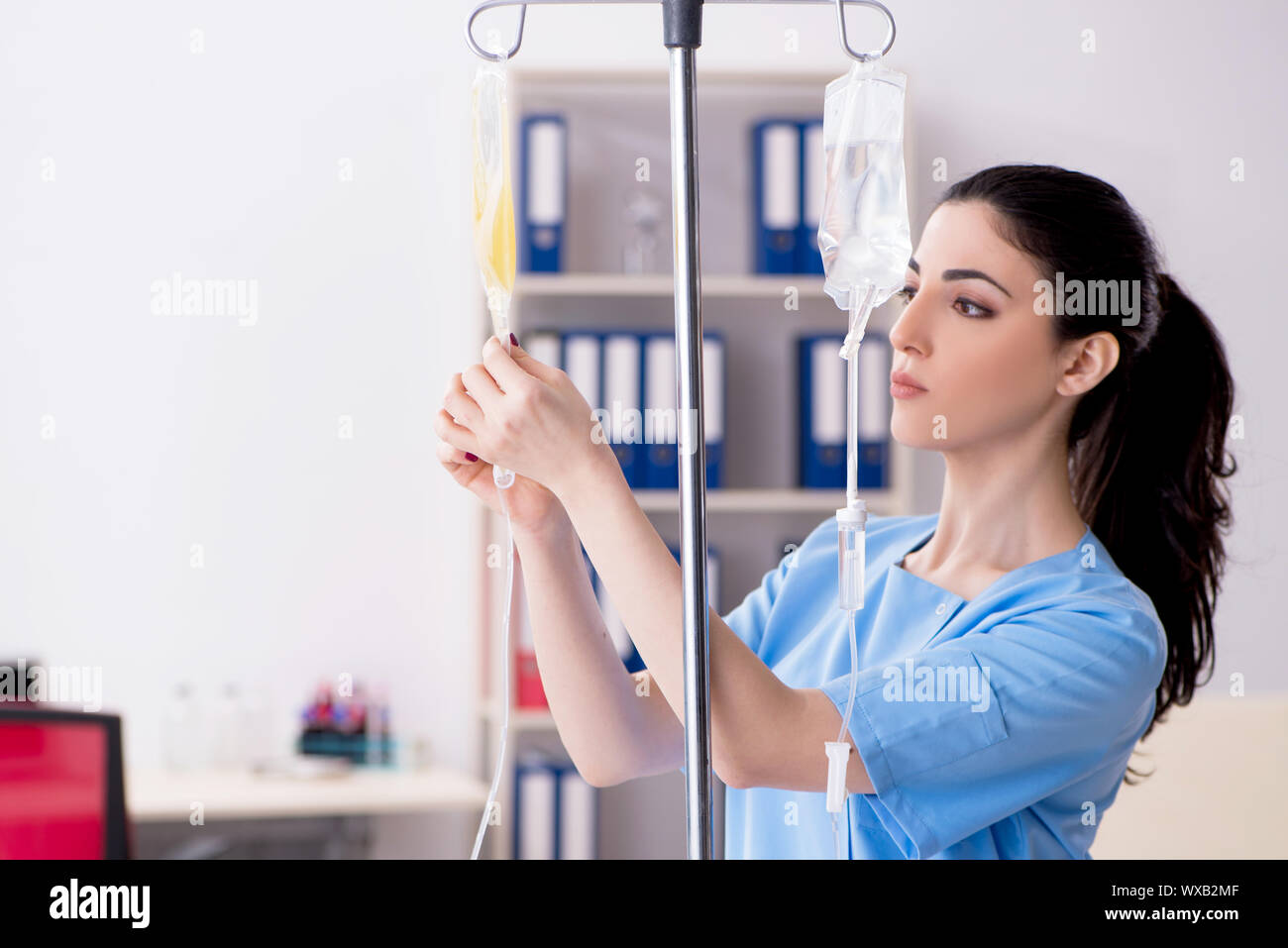 Young female doctor in infusion concept Stock Photo