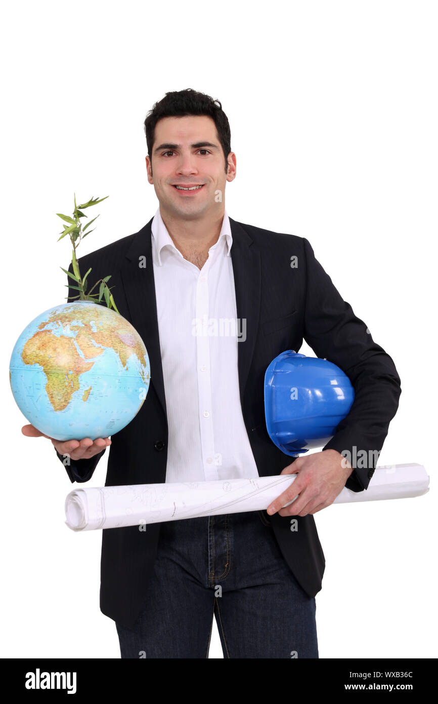 Architect holding globe and plans Stock Photo