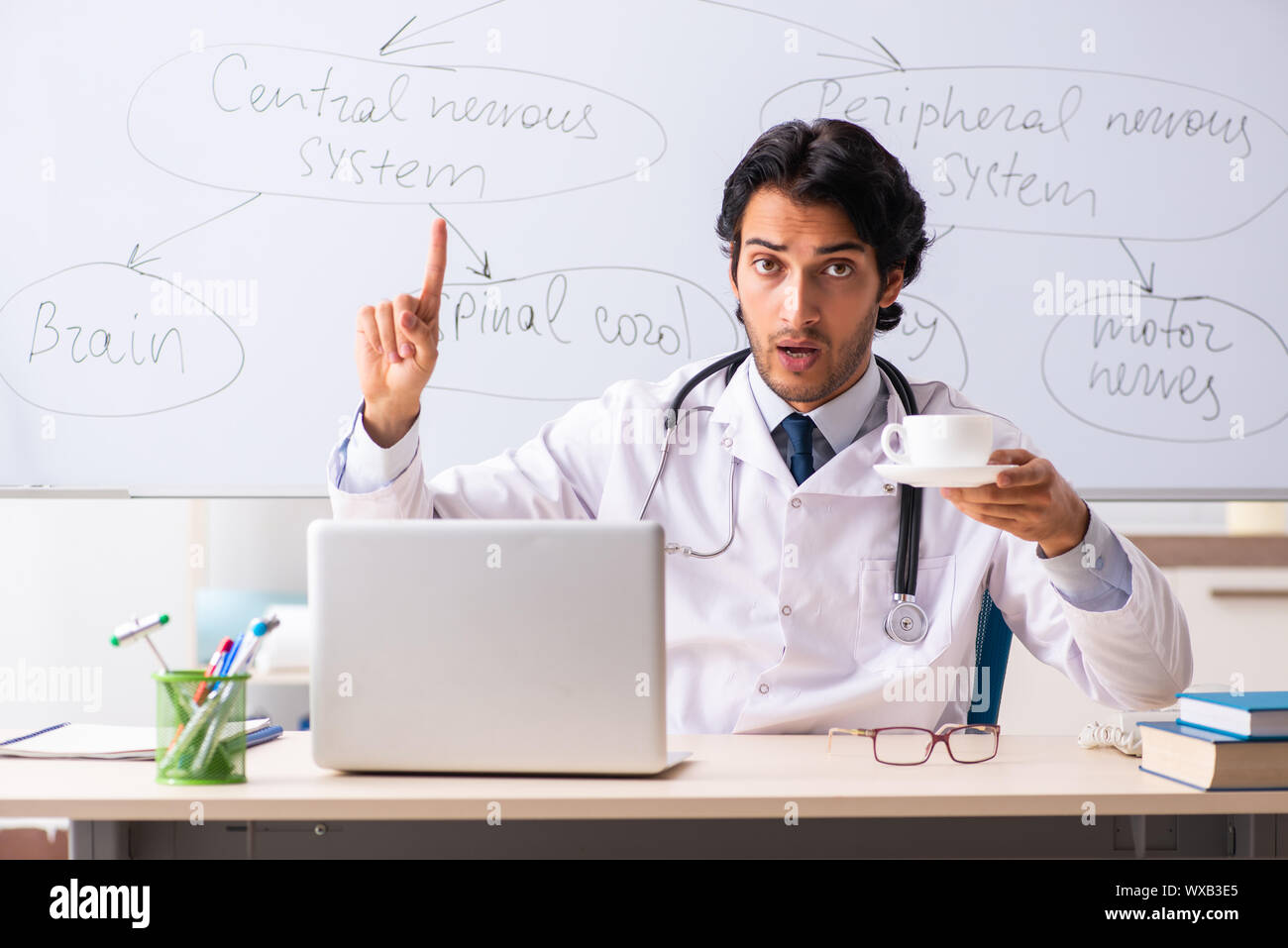 Young male doctor neurologist in front of whiteboard Stock Photo