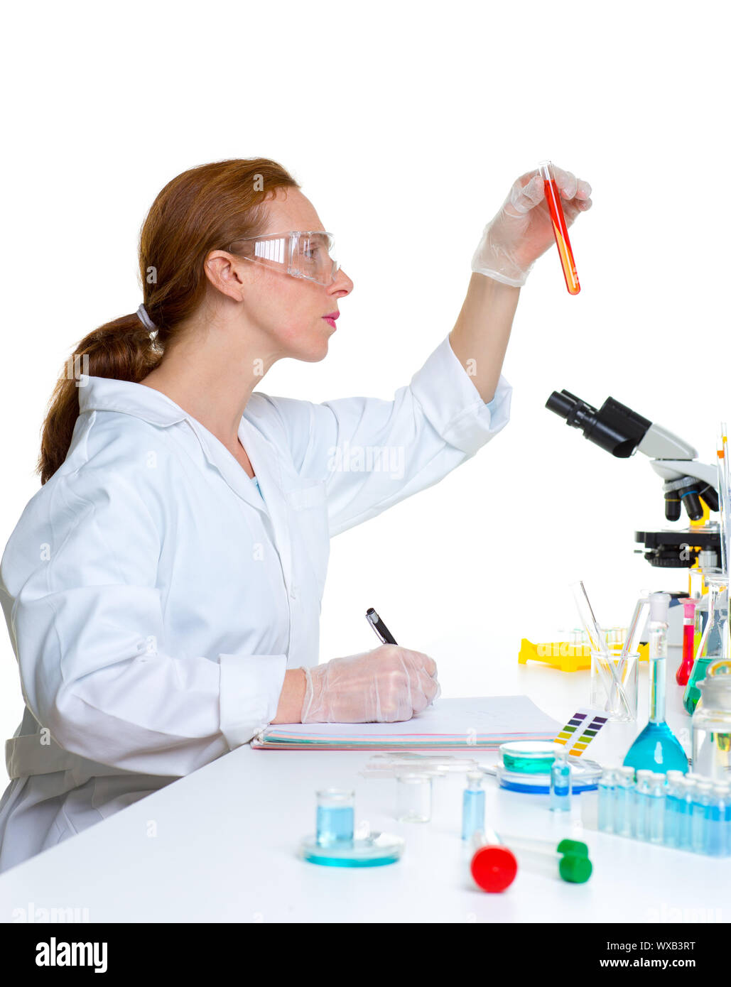 chemical laboratory scientist woman looking at test tube Stock Photo