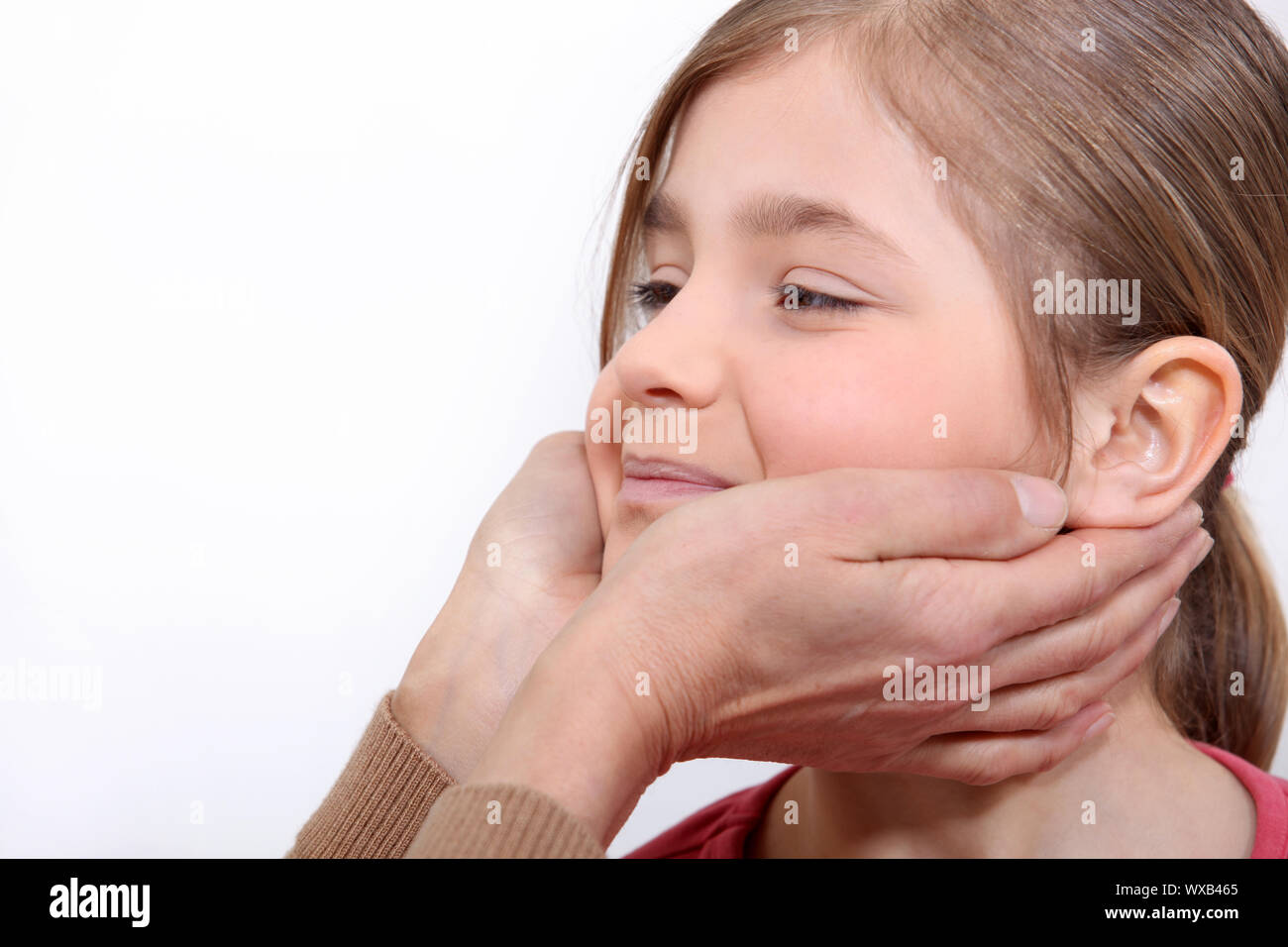 Grandmother holding her grand daughter face Stock Photo Alamy