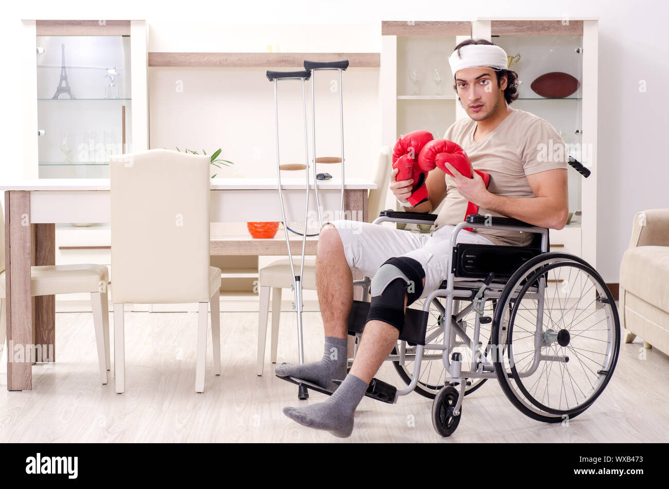 Injured young man doing exercises at home Stock Photo - Alamy