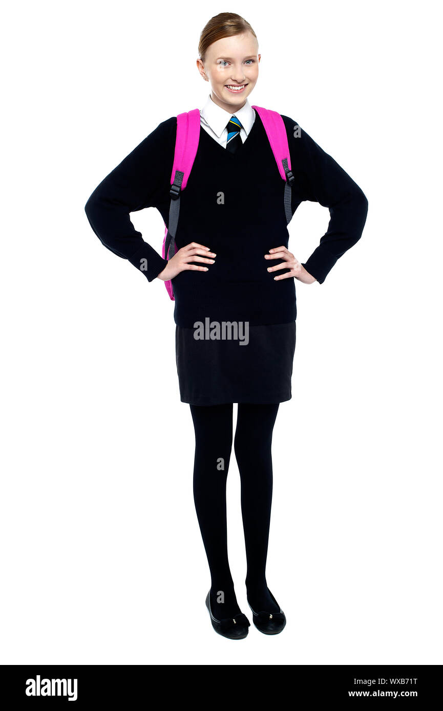 Full length portrait of confident schoolgirl posing with hands on waist. Stock Photo