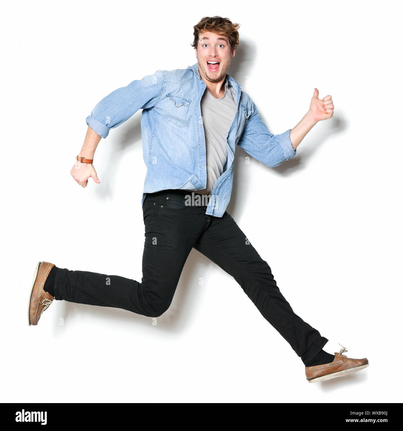 Jumping man happy excited. Funny portrait on young casual male male model in humorous jump on white background Stock Photo - Alamy Jumping man happy excited. Funny portrait on young casual male male model in humorous jump on white background Stock Photo - Alamy