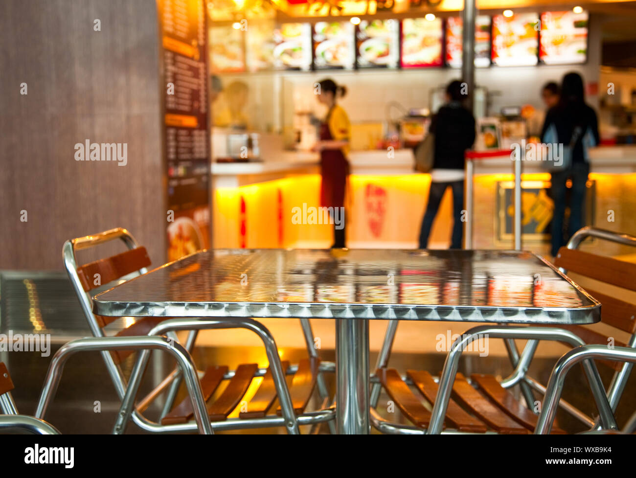 Seats and table at Chinese fast food restaurant, shallow focus Stock