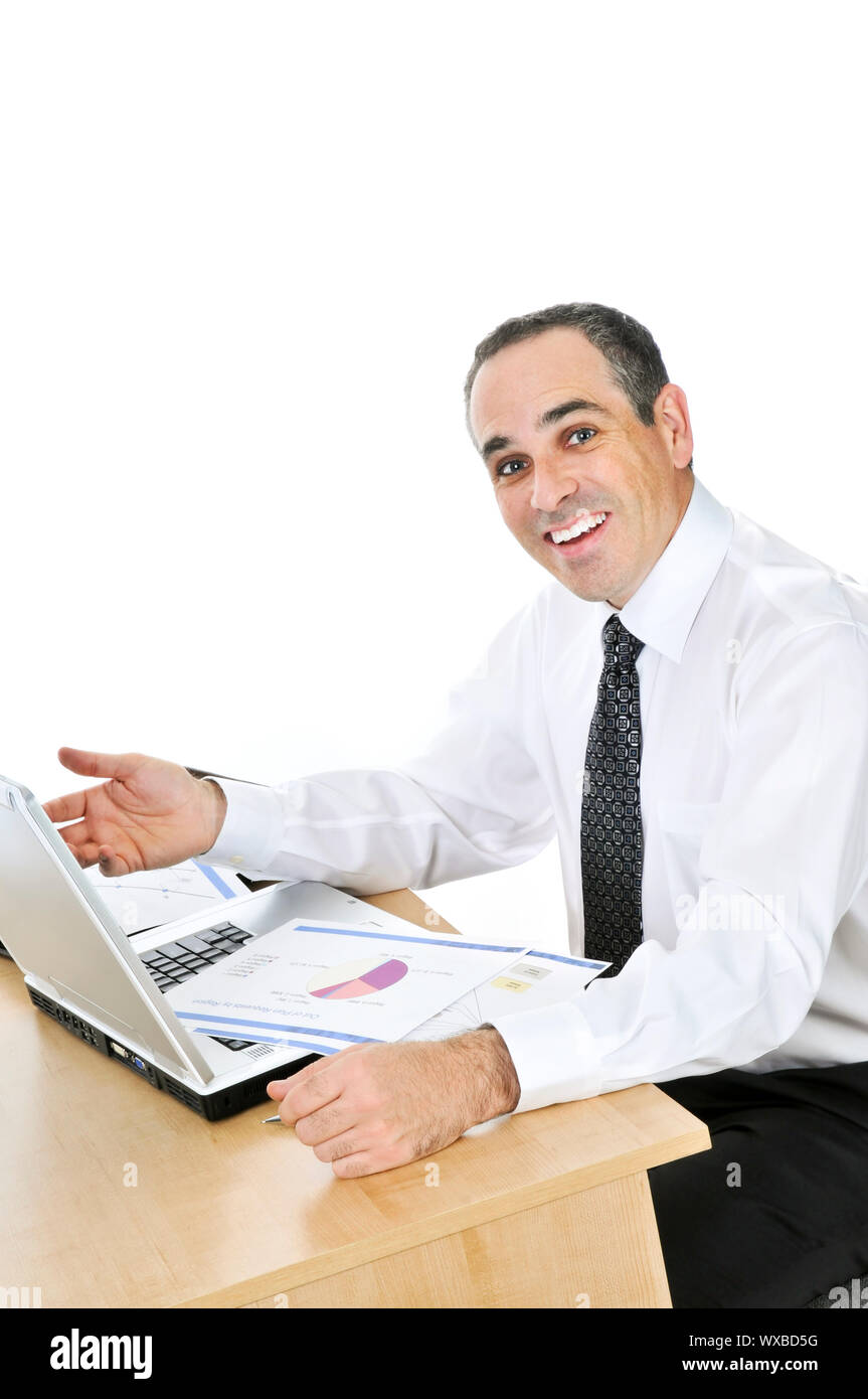 Happy smiling businessman sitting at his desk isolated on white ...