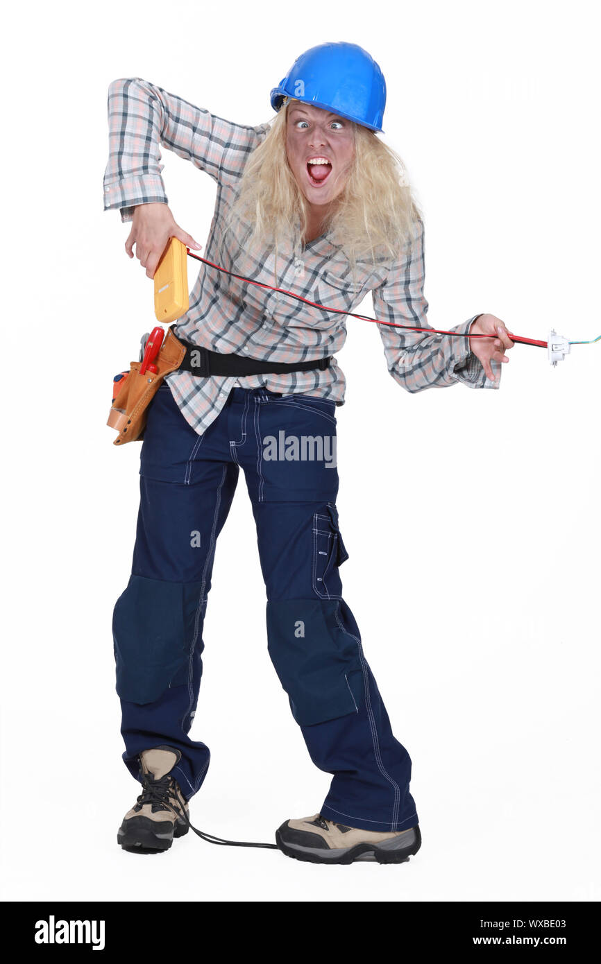 Female electrician receiving shock Stock Photo