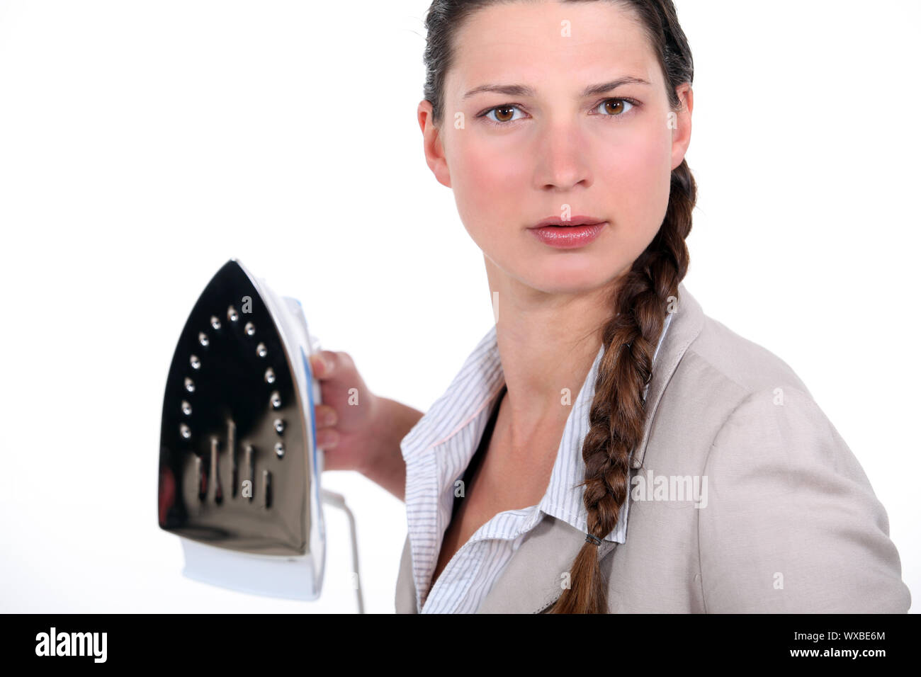 Businesswoman holding iron menacingly Stock Photo