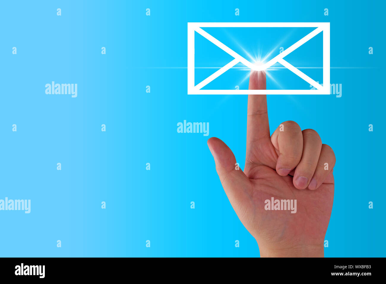Email concept, hand and envelope icon on blue background Stock Photo