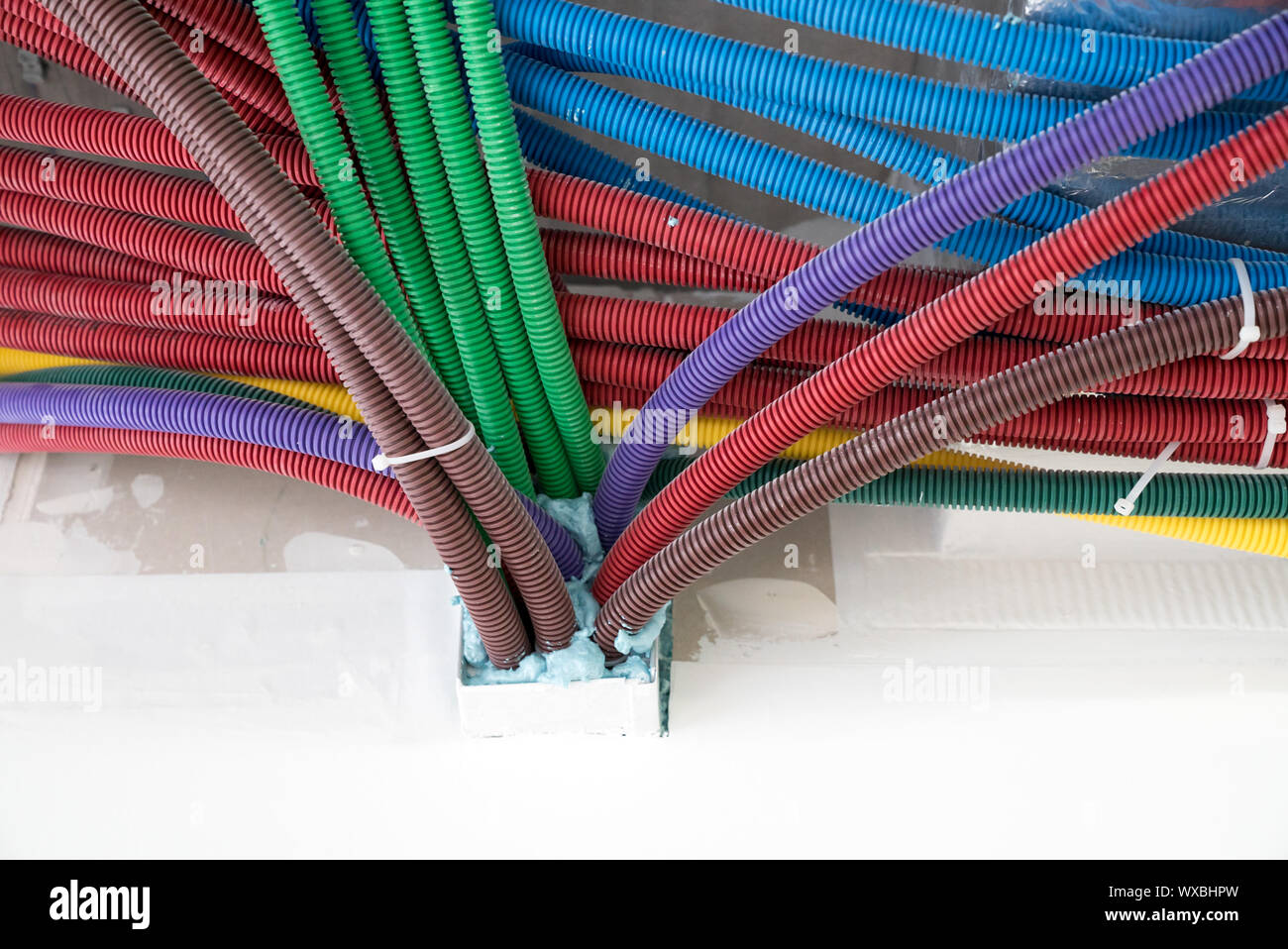 colorful plastic tubes for electrical wires in the sub ceiling in a
