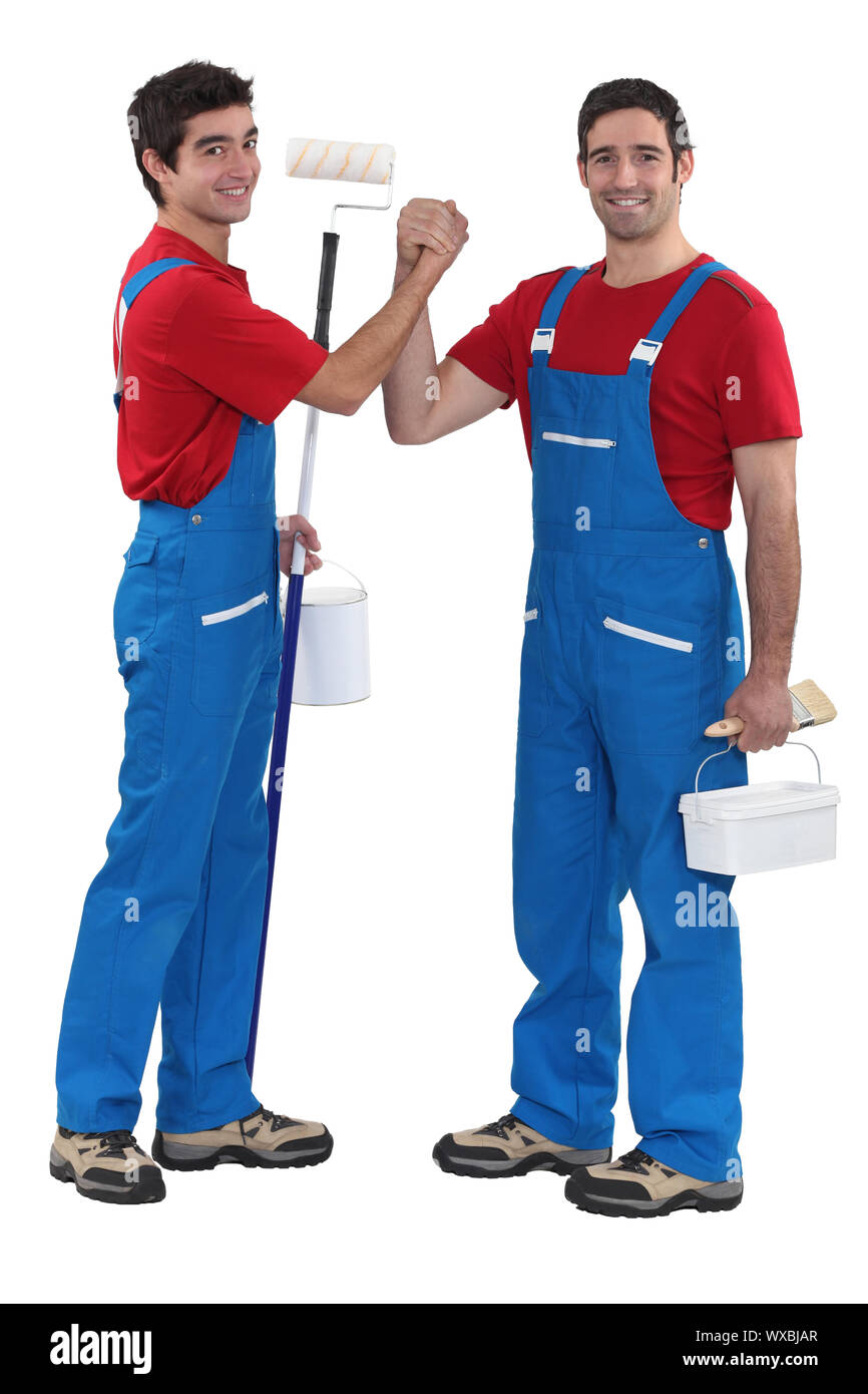 craftsman painter and his apprentice shaking hands Stock Photo