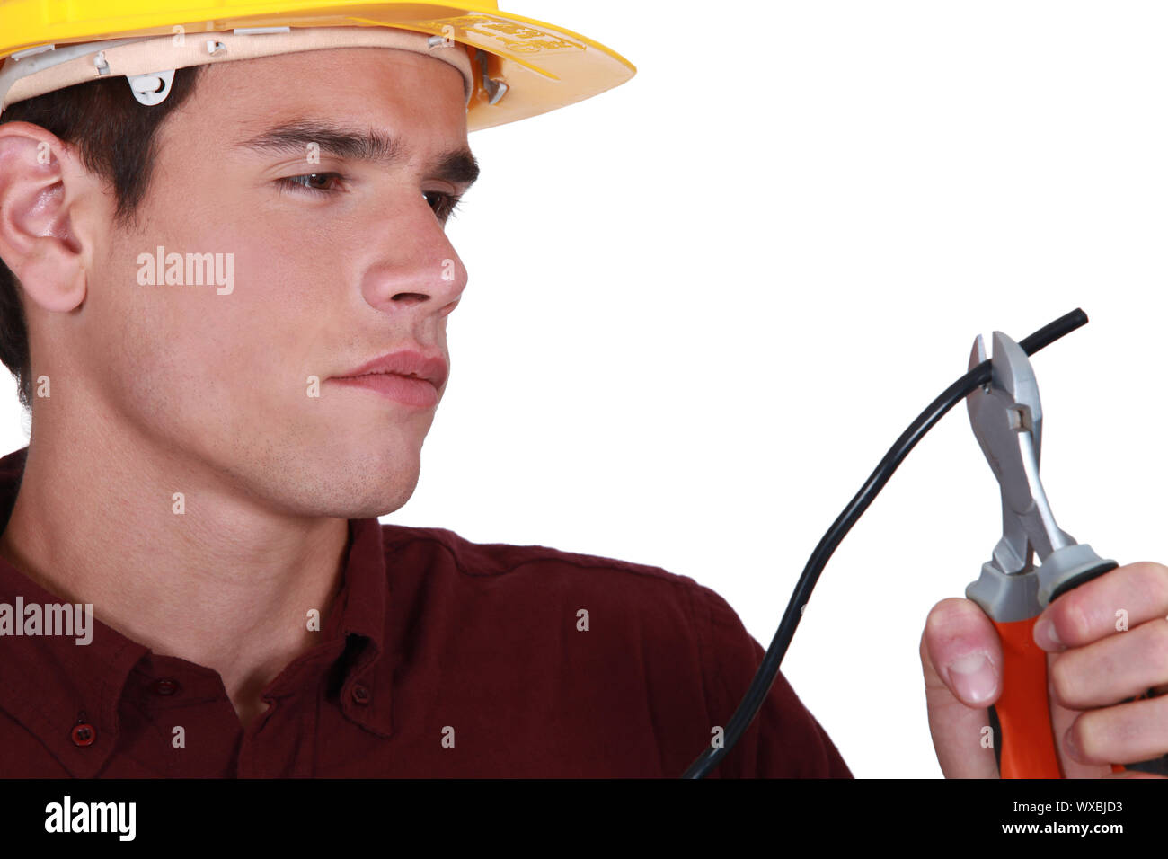 Man carefully cutting electrical wire Stock Photo Alamy