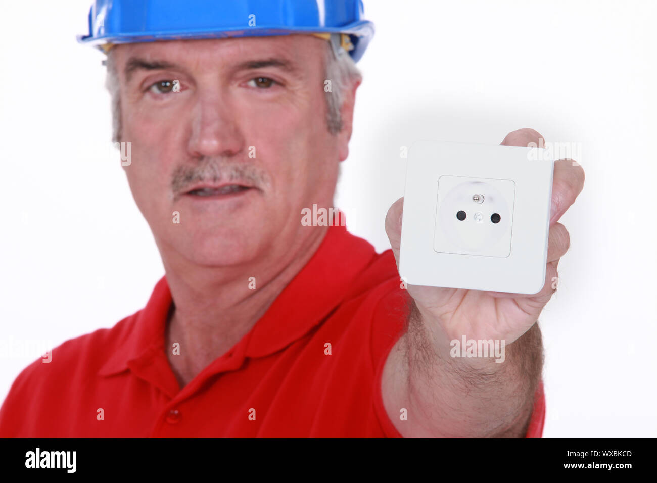 Electrician with a continental two pin wall socket Stock Photo