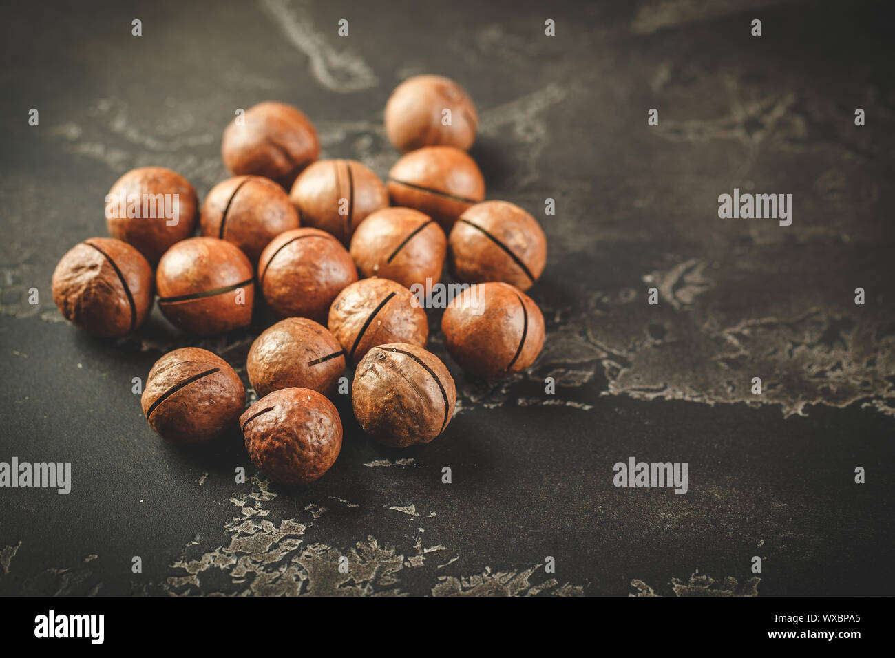 Macadamia nuts on wooden table Stock Photo