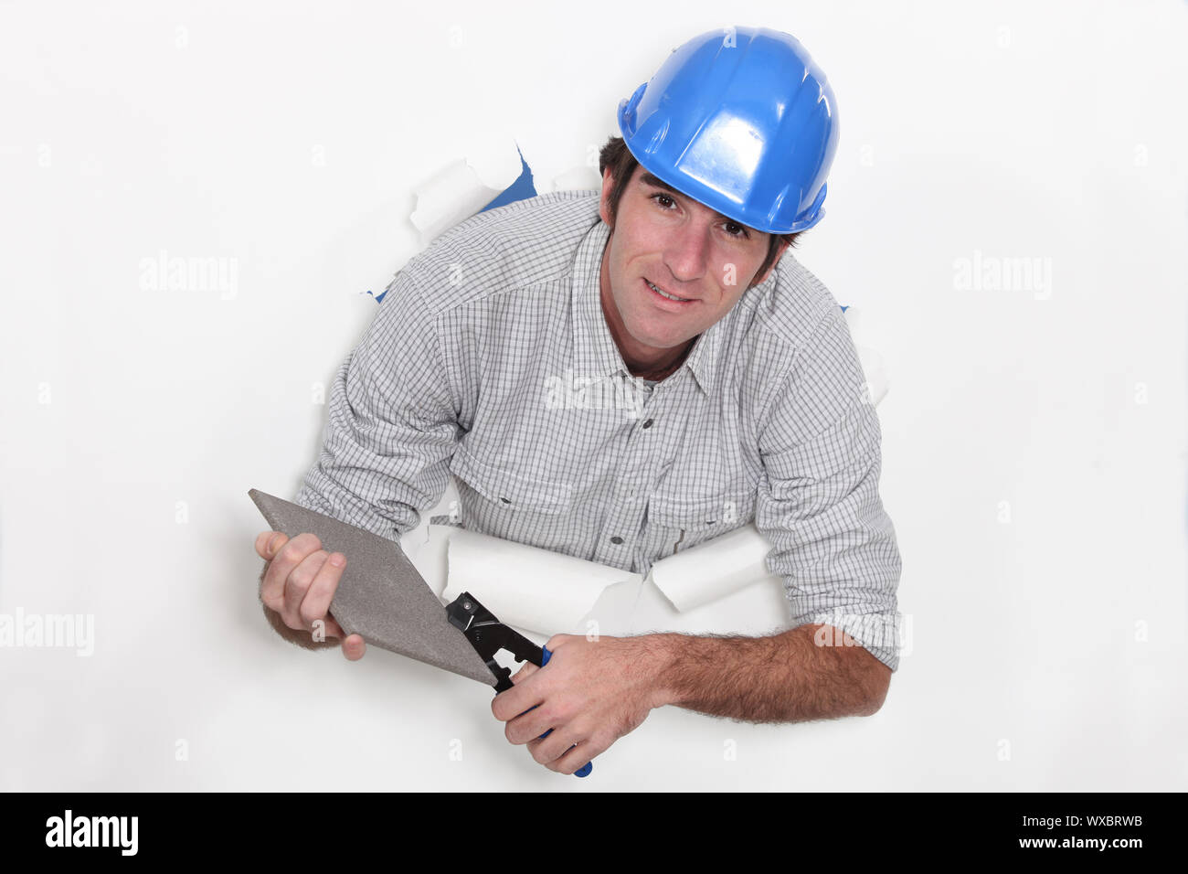 Workman using tile nibblers Stock Photo Alamy