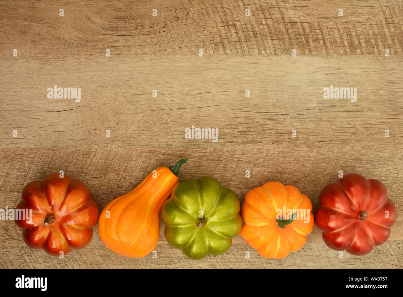 Ornamental pumpkin border on rustic wood background from overhead. Room ...