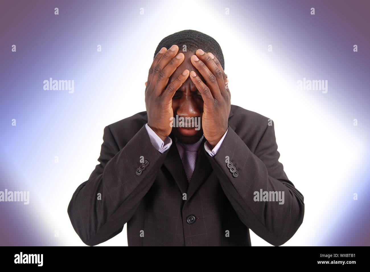 This is an image of a business man with his hands to his head. This image can represent 'Bad news', 'Poor Investment', 'Confusion' etc.. Stock Photo