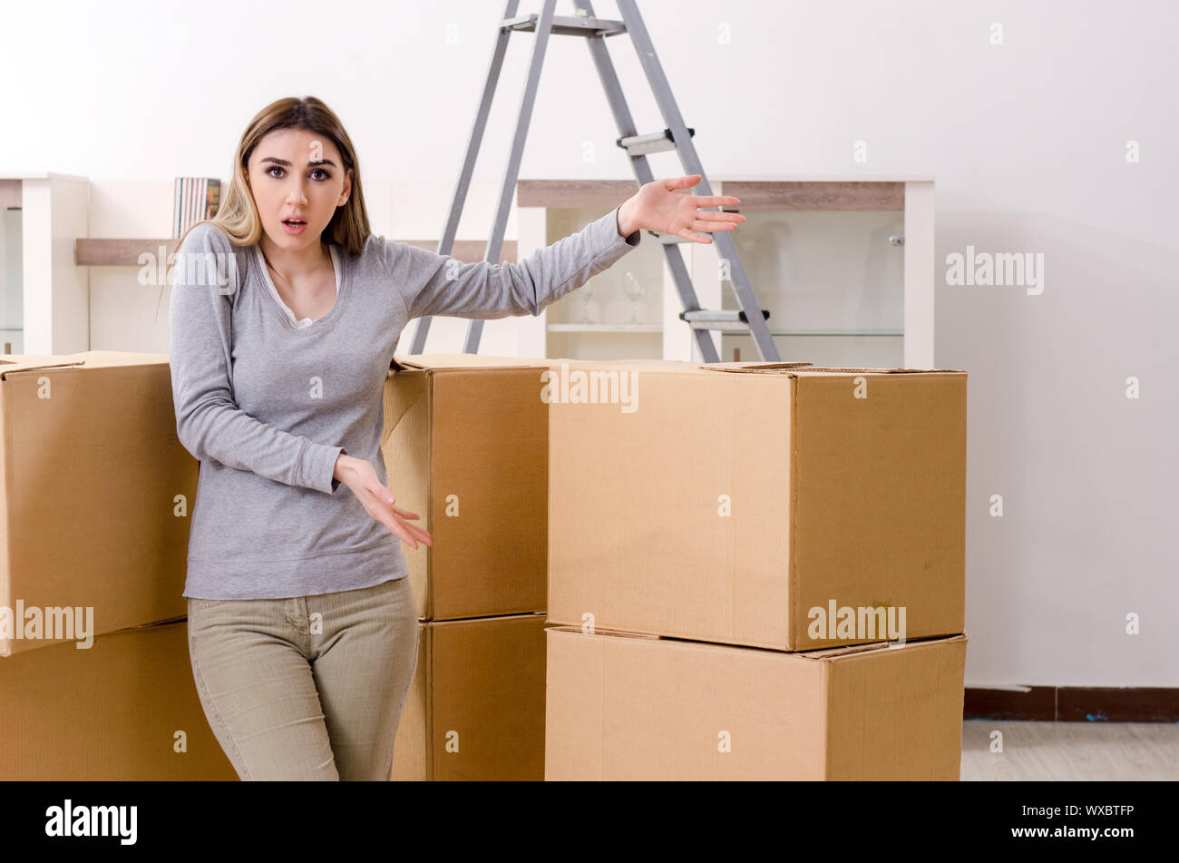 Young beautiful woman moving to new flat Stock Photo