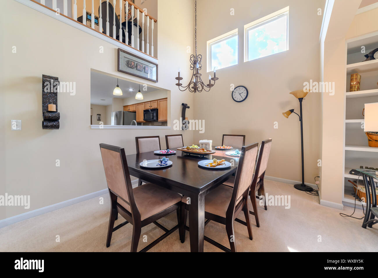 A kitchen in a suburban American home with a partially set table. Stock Photo