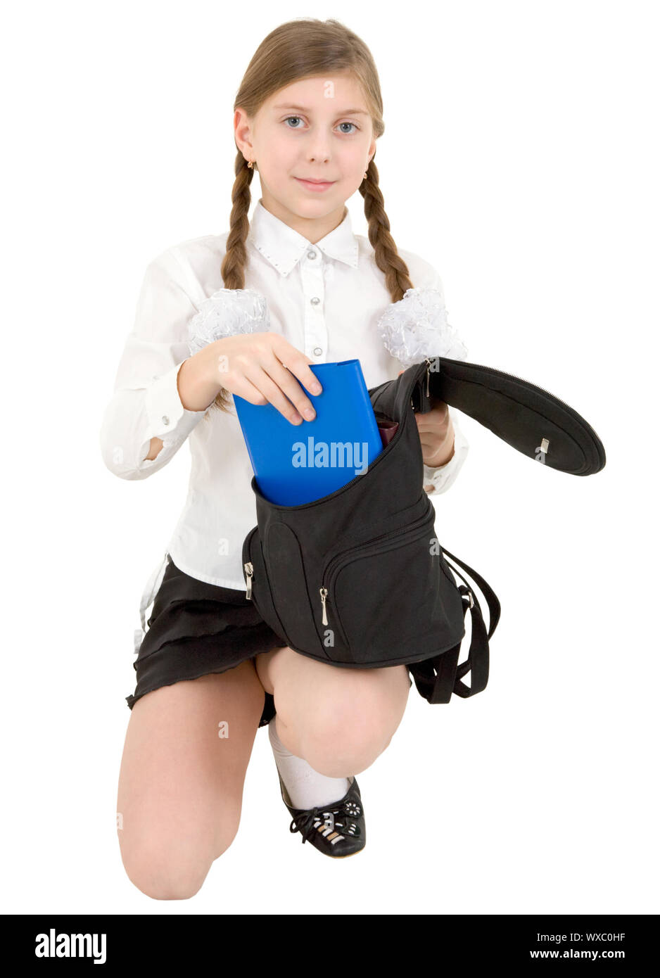 Schoolgirl and book on the white background Stock Photo - Alamy