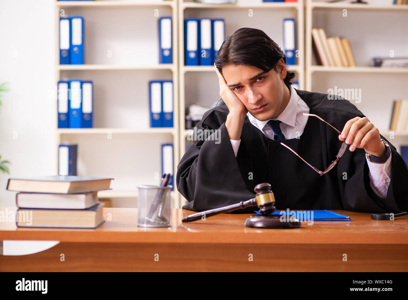 Young handsome judge working in court Stock Photo