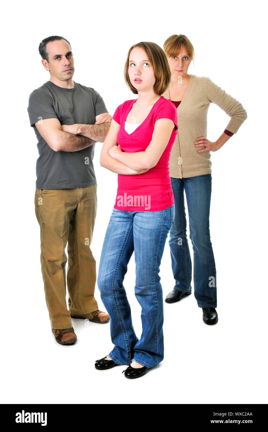 Teenage girl rolling her eyes in front of angry parents Stock Photo