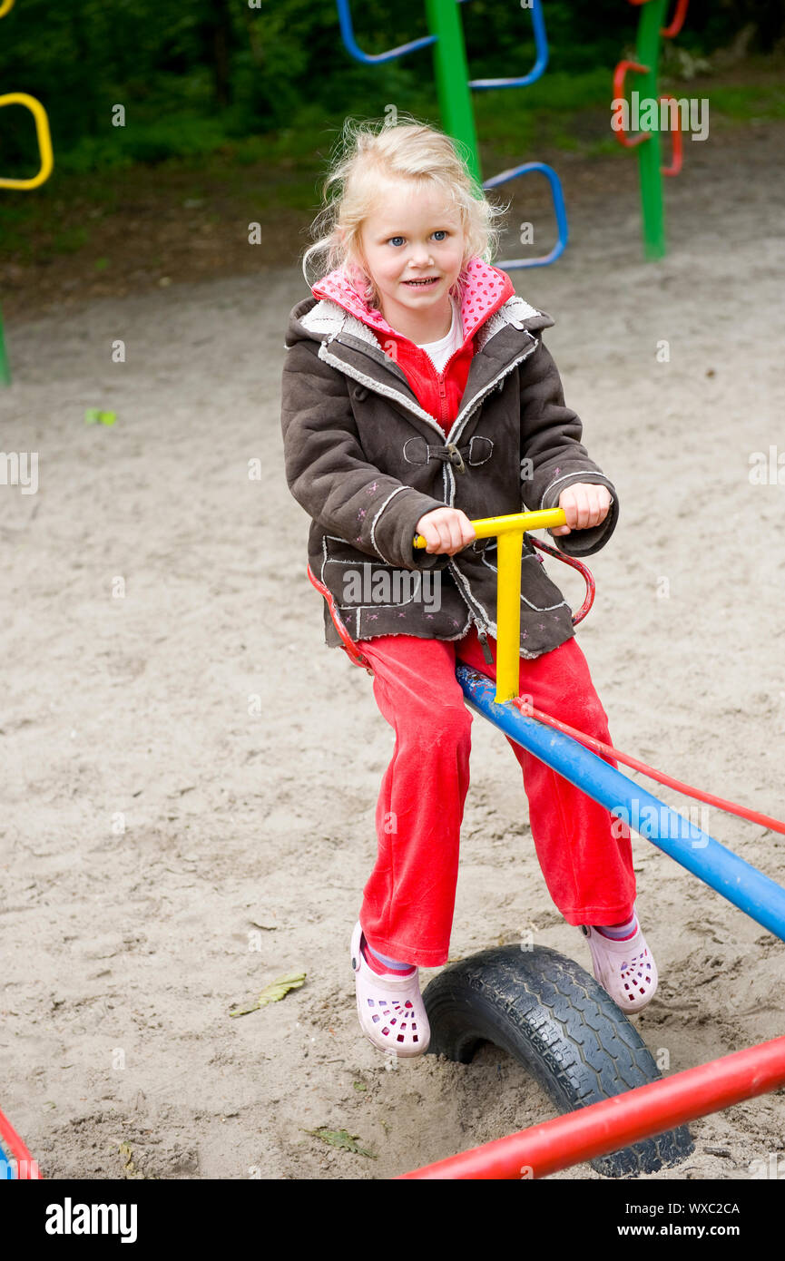 Little girl is playing at the playground Stock Photo - Alamy