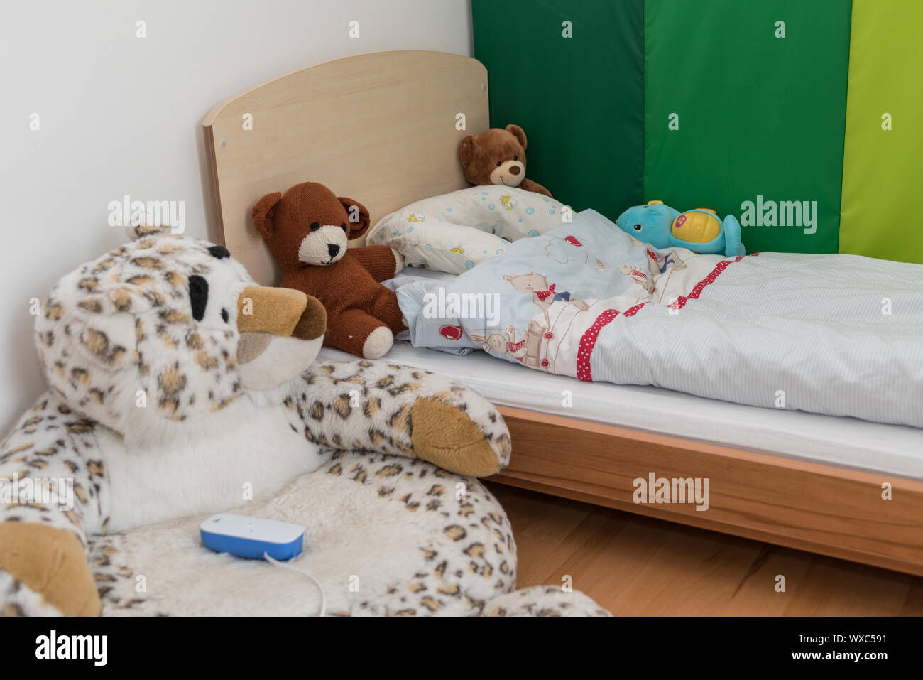 Feel-good corner in the nursery with babyphone and stuffed animals Stock Photo