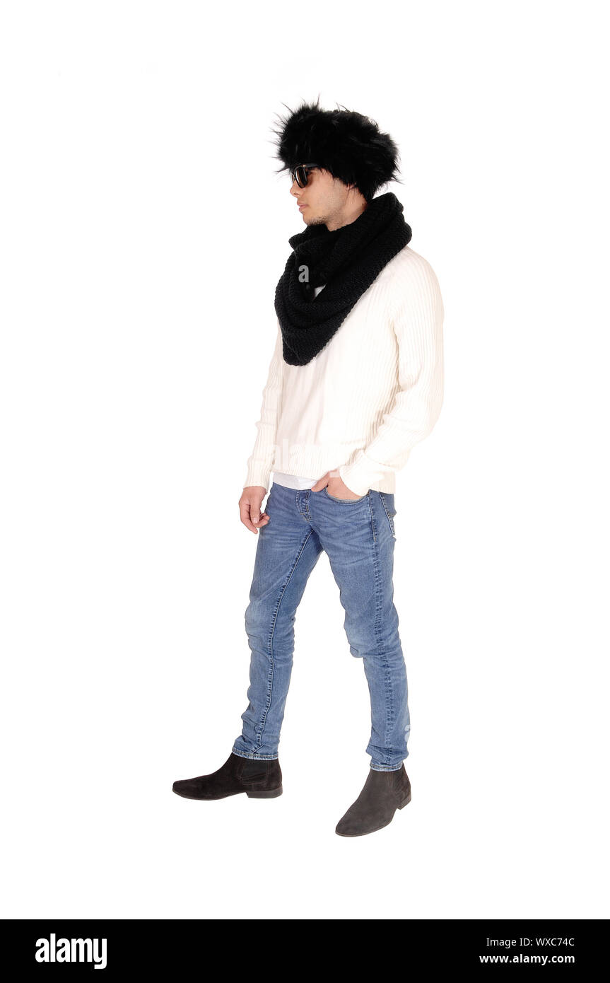 Tall young man standing in profile with fur hat Stock Photo