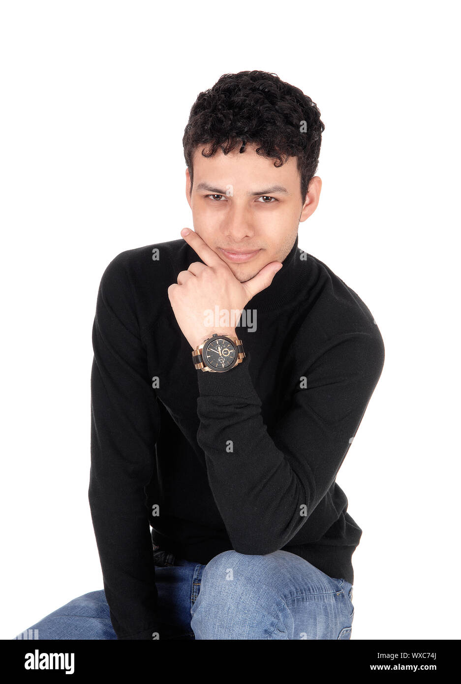 Handsome good looking man sitting on chair Stock Photo